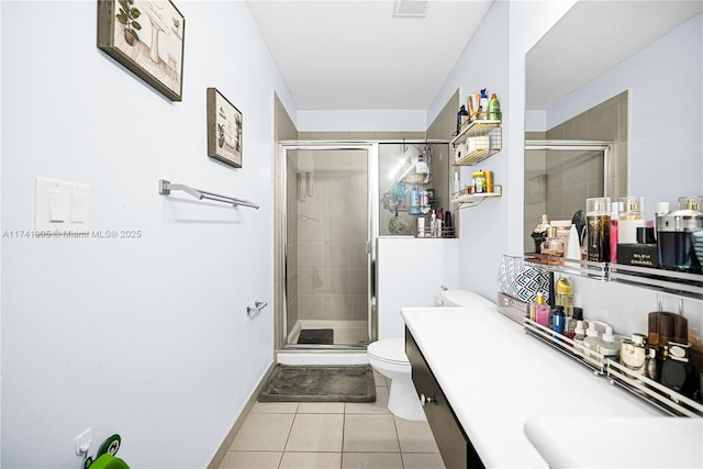 bathroom featuring vanity, tile patterned flooring, a shower with shower door, and toilet