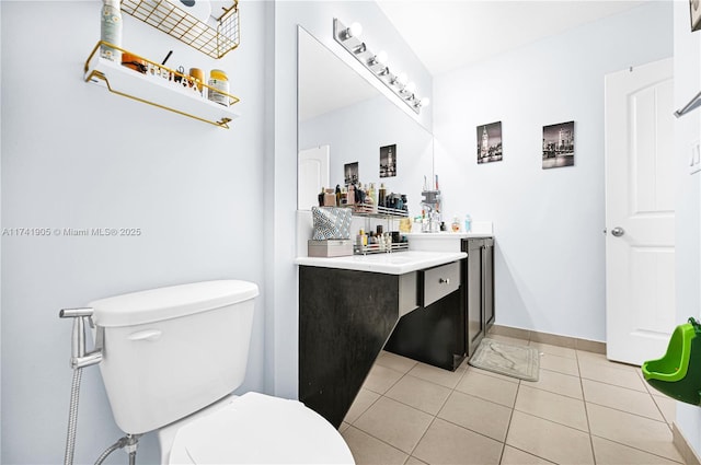 bathroom with vanity, toilet, and tile patterned flooring