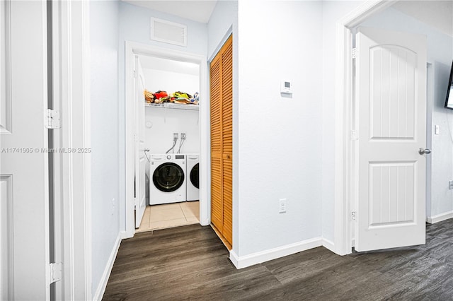 washroom featuring dark wood-type flooring and independent washer and dryer