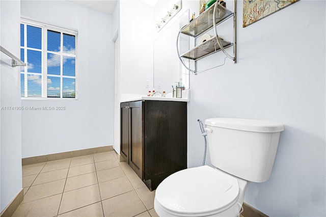 bathroom with tile patterned flooring, vanity, and toilet