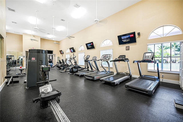 gym with a towering ceiling and ceiling fan