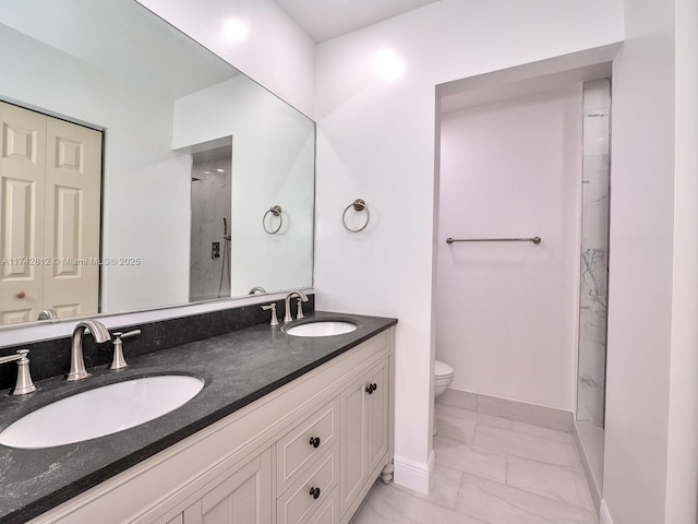 bathroom with vanity, a shower, and toilet