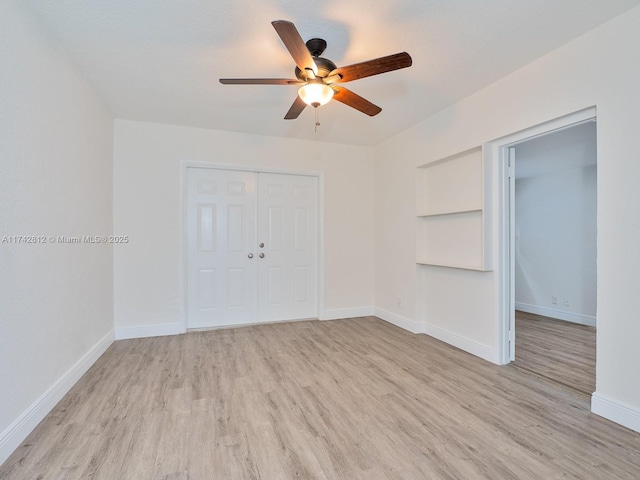 unfurnished bedroom featuring light hardwood / wood-style floors, a closet, and ceiling fan