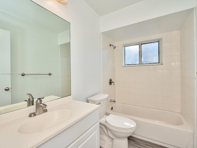 full bathroom with vanity, tiled shower / bath combo, toilet, and hardwood / wood-style flooring