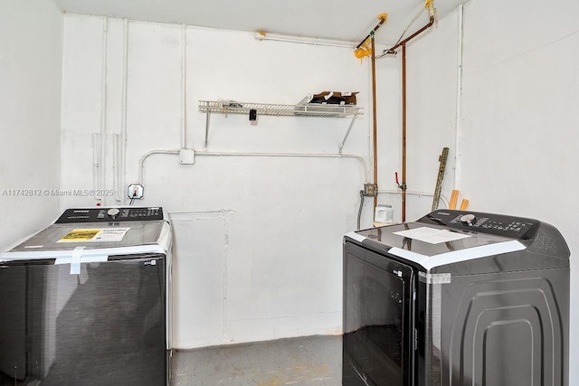 clothes washing area with independent washer and dryer