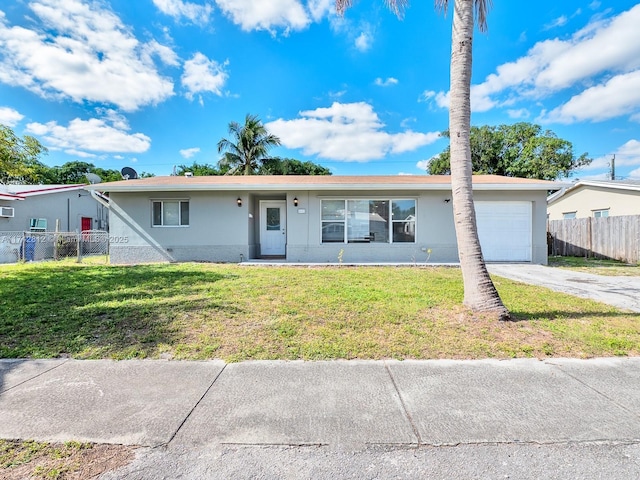 single story home with a garage and a front lawn