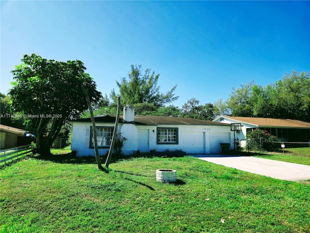 single story home with driveway, a garage, fence, and a front lawn