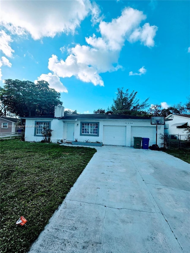 single story home with a garage and a front yard