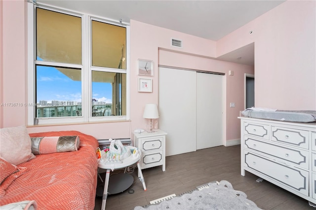 3330 NE 190th St Unit 1715, Aventura, FL 33180 - bedroom featuring wood finished floors, a closet, and a baseboard radiator