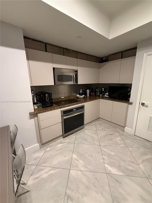 3330 NE 190th St Unit 1715, Aventura, FL 33180 - kitchen featuring appliances with stainless steel finishes, light marble finish flooring, and white cabinetry