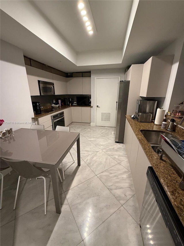 3330 NE 190th St Unit 1715, Aventura, FL 33180 - kitchen with stainless steel appliances, a raised ceiling, white cabinetry, and modern cabinets