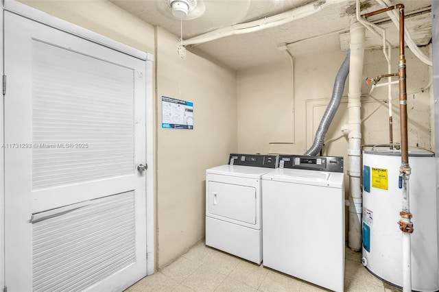 clothes washing area featuring separate washer and dryer and electric water heater