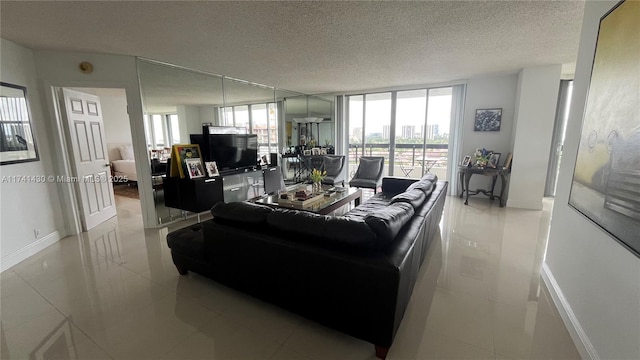 living room with baseboards, light tile patterned floors, floor to ceiling windows, and a textured ceiling