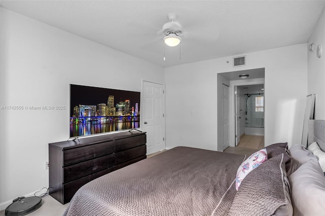 bedroom with light tile patterned flooring and ensuite bathroom