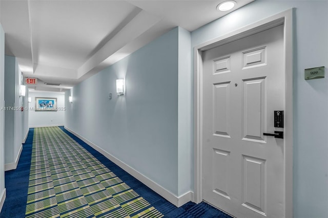 hallway featuring dark carpet