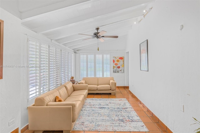 living room featuring ceiling fan, lofted ceiling with beams, and light tile patterned floors