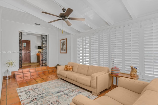 living room featuring vaulted ceiling with beams, ceiling fan, and light tile patterned floors