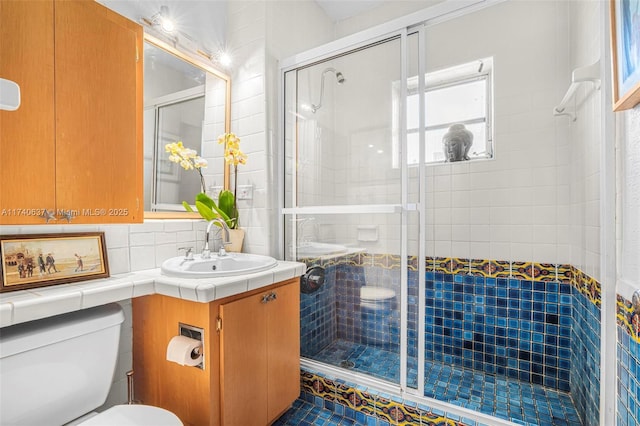 bathroom featuring toilet, vanity, backsplash, and walk in shower