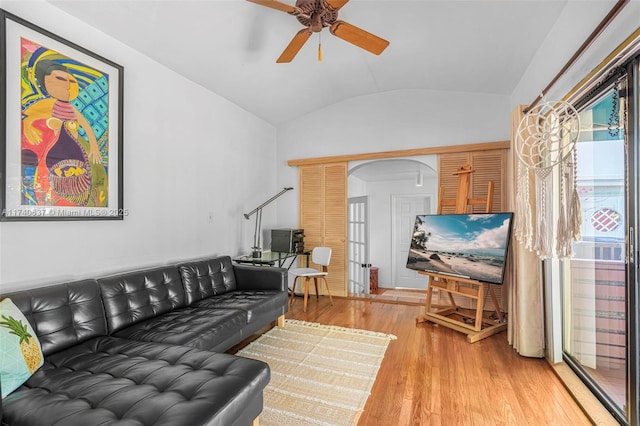 living room featuring hardwood / wood-style flooring, ceiling fan, and vaulted ceiling