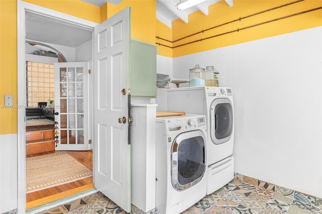 laundry area featuring french doors and separate washer and dryer