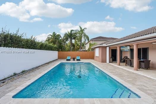 view of swimming pool featuring a patio area