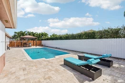 view of pool with a gazebo and a patio