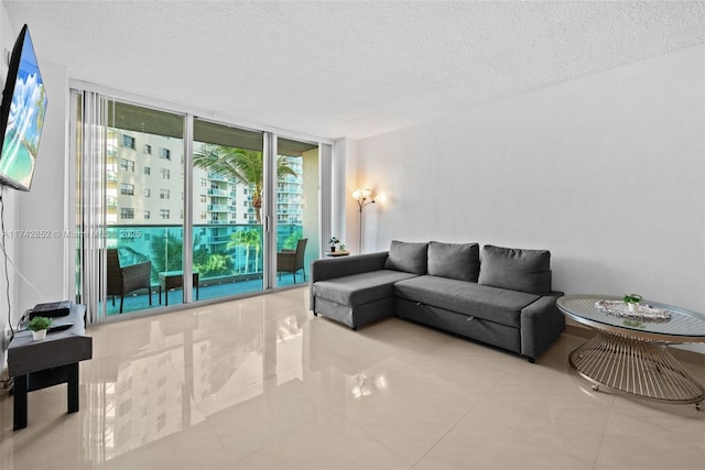 living room with expansive windows and a textured ceiling