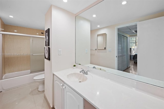 full bathroom featuring shower / bath combination with glass door, recessed lighting, toilet, vanity, and tile patterned floors