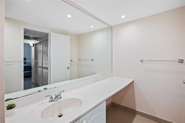 bathroom with recessed lighting, connected bathroom, vanity, tile patterned flooring, and baseboards