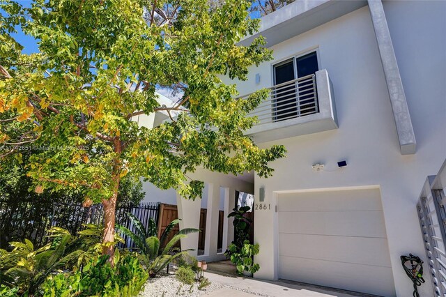 view of front of property with a garage and a balcony