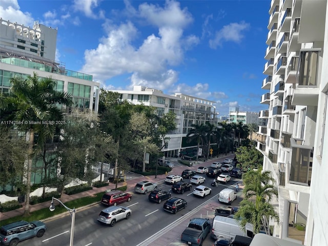 view of property with a view of city and uncovered parking