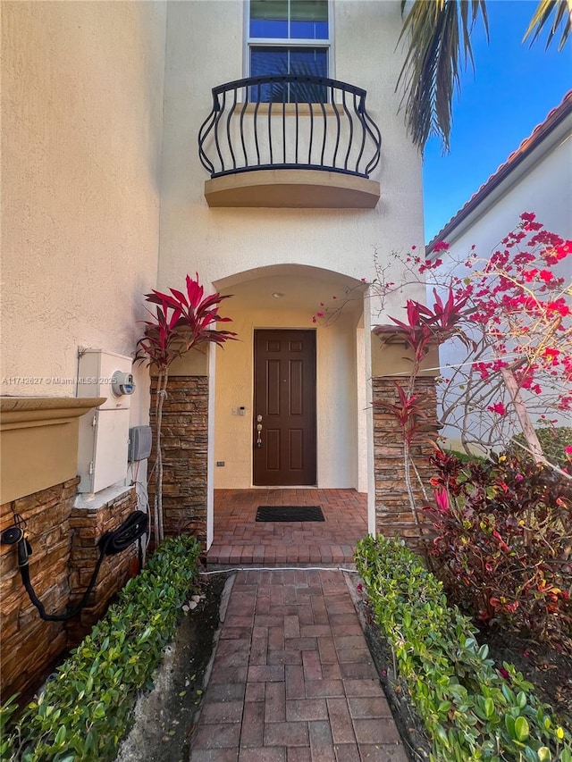 6411 Osprey Landing St, Davie, FL 33314 - property entrance featuring a balcony, stone siding, and stucco siding