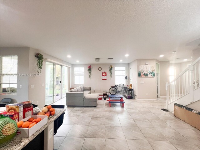 6411 Osprey Landing St, Davie, FL 33314 - living room featuring stairs, recessed lighting, a textured ceiling, and light tile patterned floors