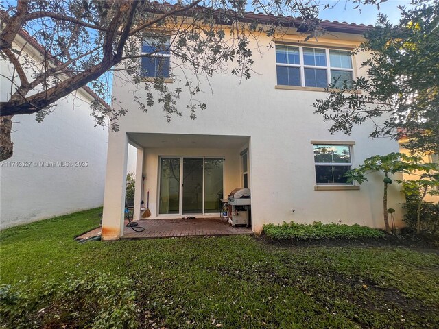 6411 Osprey Landing St, Davie, FL 33314 - back of house with stucco siding, a yard, and a patio area
