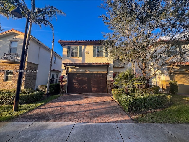 6411 Osprey Landing St, Davie, FL 33314 - view of front of house with stucco siding, an attached garage, a tile roof, and decorative driveway