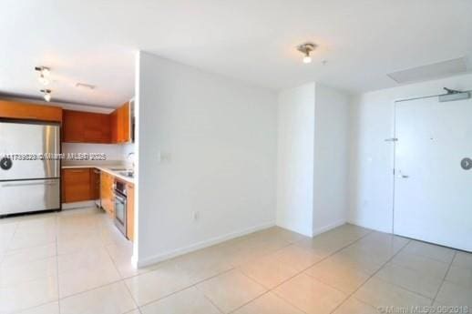 kitchen featuring light tile patterned flooring and stainless steel appliances