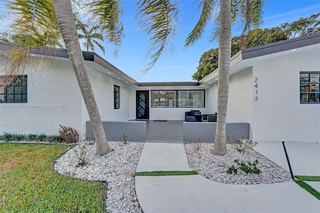 view of exterior entry featuring a patio