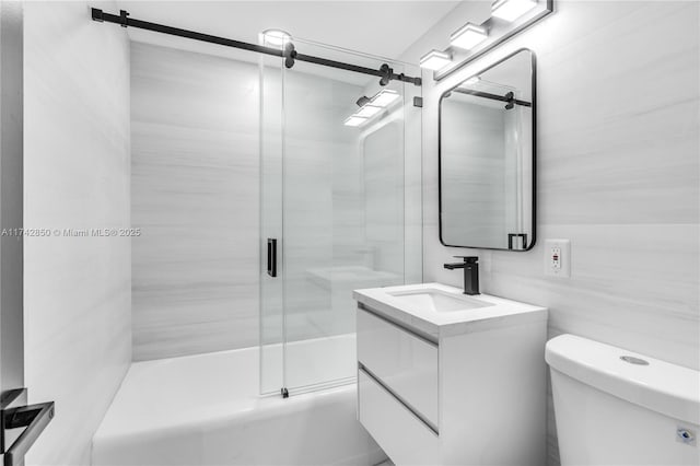 full bathroom with vanity, bath / shower combo with glass door, and toilet