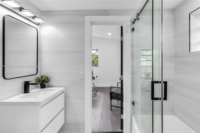 bathroom with vanity, wood-type flooring, and independent shower and bath