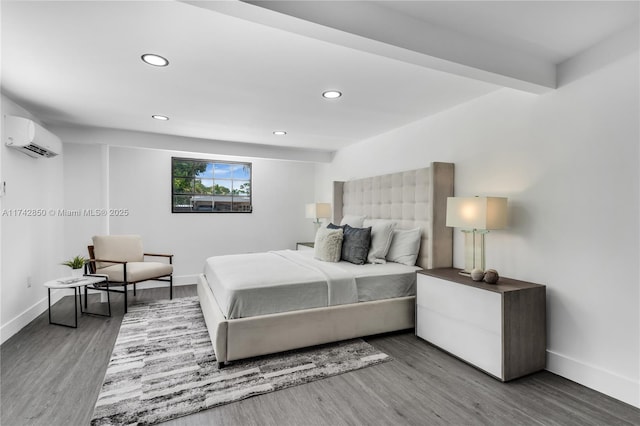 bedroom with hardwood / wood-style floors and a wall unit AC