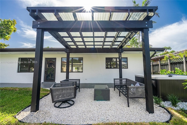 view of patio with a hot tub, an outdoor hangout area, and a pergola