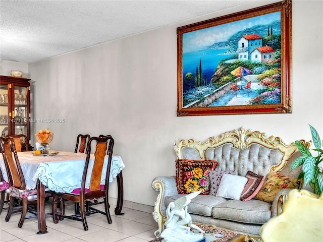 dining area featuring light tile patterned flooring and a textured ceiling