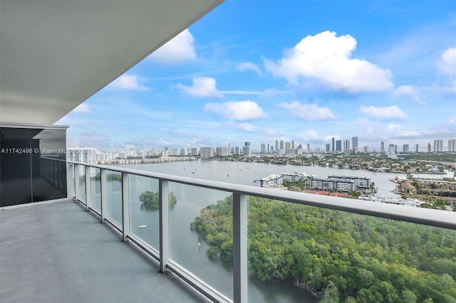 balcony with a water view and a view of city