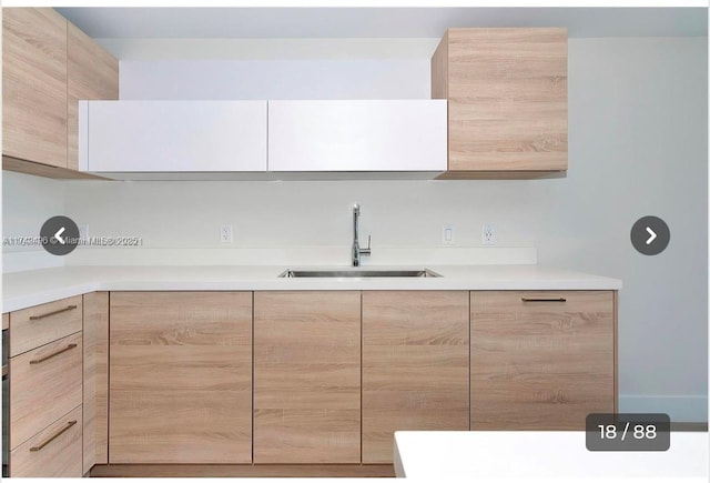 kitchen featuring sink and light brown cabinets