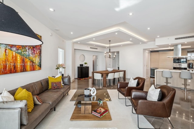 tiled living room with a notable chandelier and a raised ceiling