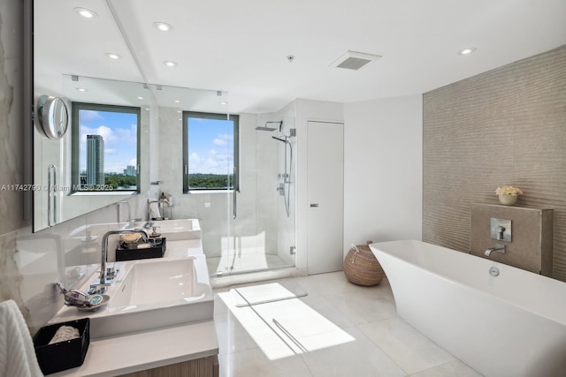 bathroom with vanity, separate shower and tub, tile walls, and tile patterned floors