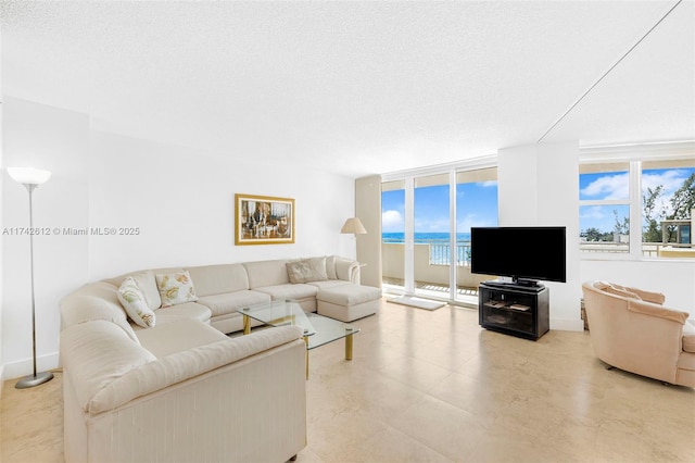 living room featuring floor to ceiling windows and a textured ceiling