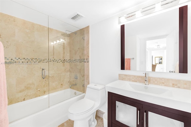 full bathroom with shower / bath combination with glass door, vanity, toilet, and backsplash