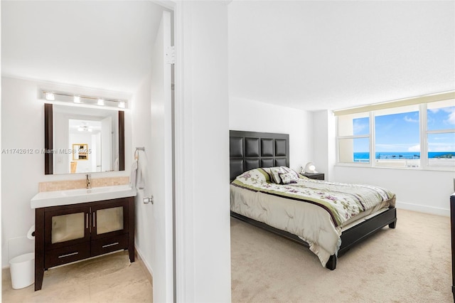 bedroom featuring sink and light carpet