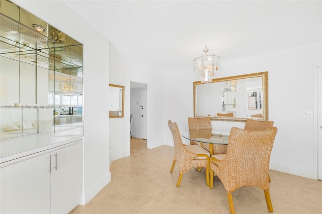 dining area with an inviting chandelier and a textured ceiling